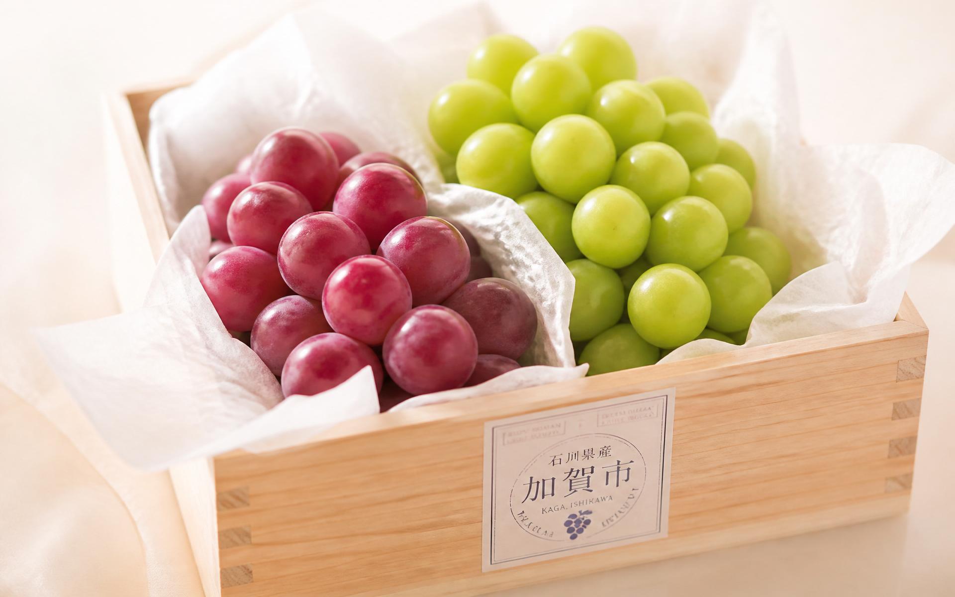 Premium Japanese Ruby Roman and Shine Muscat grapes in a wooden crate